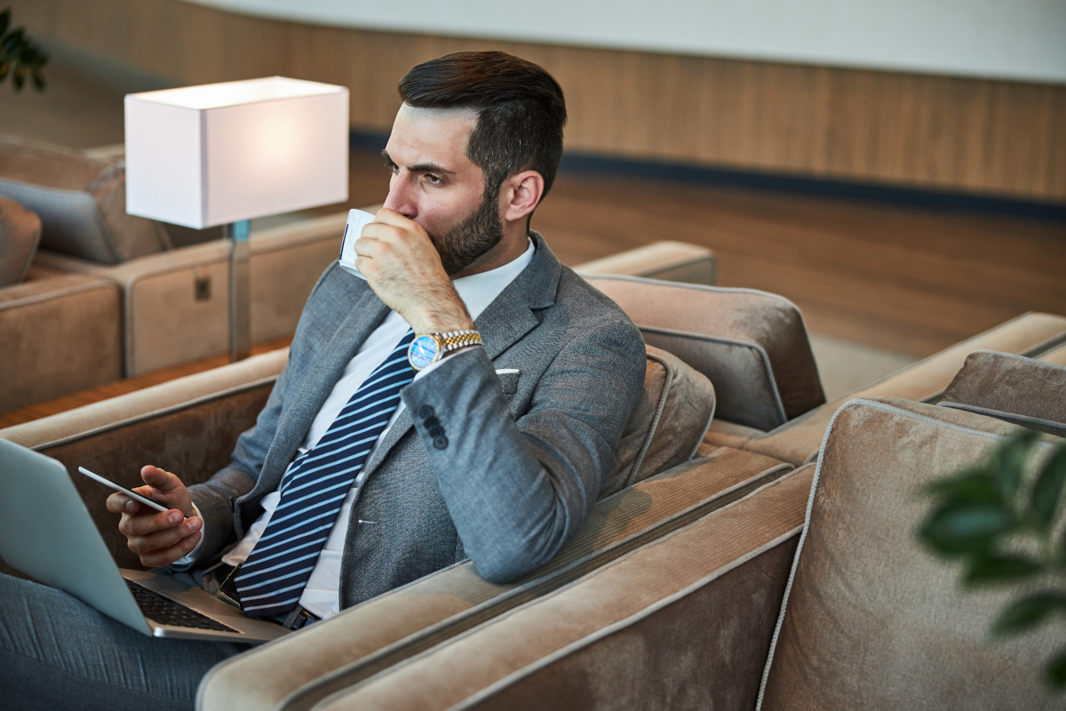 Fashionable business man drinking coffee.