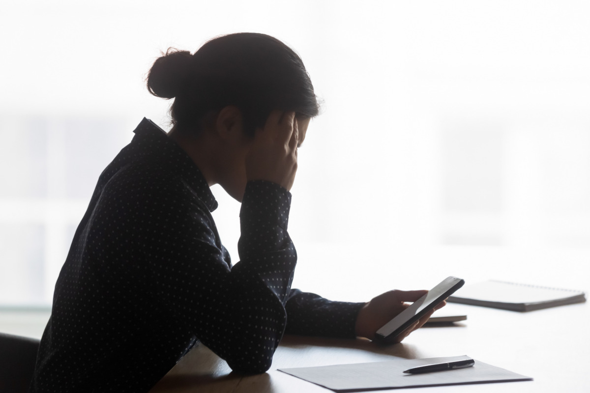 Side view stressed young woman waiting for phone call.